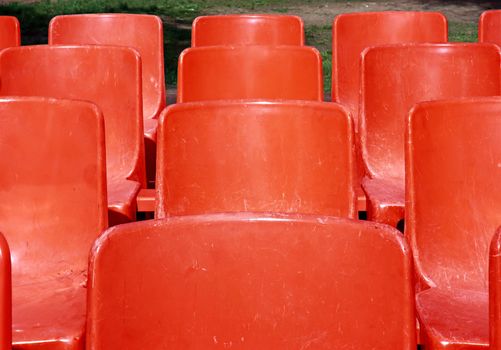 Empty red seats at the park 