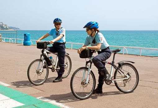 NICE, FRANCE - MAY 2: Women police officers on bicycles. Côte d'Azur, the Promenade des Anglais on May 2, 2013 in Nice, France. Bikes are very popular among municipal employees

Nice, France - May 2, 2013: Women police officers on bicycles. Côte d'Azur, the Promenade des Anglais. Bikes are very popular among municipal employees.