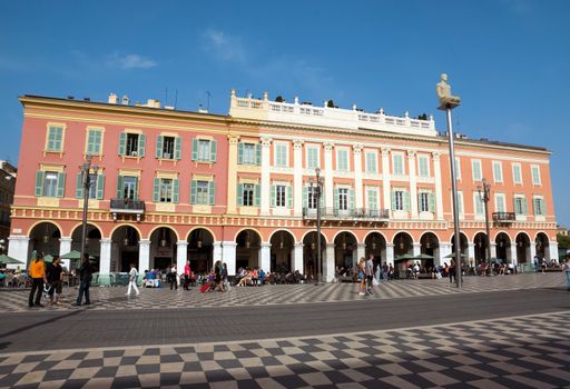 NICE, FRANCE - MAY 2: Plaza Massena Square on May 2, 2013 in Nice, France. 

Nice, France - May 2, 2013: Plaza Massena Square. People are resting and walking along square.