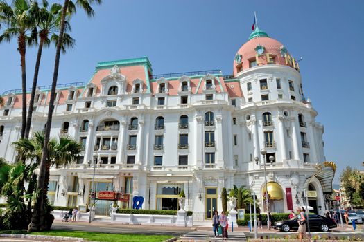 NICE, FRANCE - MAY 2: Luxury Hotel Negresco on May 2, 2013 in Nice, France. Hotel Negresco is the famous luxury hotel on the Promenade des Anglais in Nice, a symbol of the Cote d'Azur.

Nice, France - May 2, 2013: Luxury Hotel Negresco on English Promenade in Nice, French Riviera. Hotel Negresco is the famous luxury hotel on the Promenade des Anglais in Nice, a symbol of the Cote d'Azur. People walk by street.