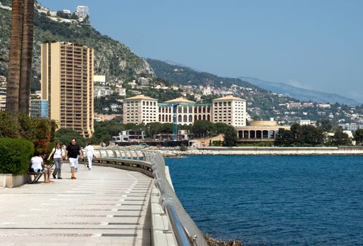 MONTE CARLO, MONACO - MAY 1: Larvotto Promenade on May 1, 2013 in Monte Carlo, Monaco. Larvotto is a part of the district of Monte Carlo in the Principality of Monaco.

Monte Carlo, Monaco - May 1, 2013: Larvotto Promenade. Larvotto is a part of the district of Monte Carlo in the Principality of Monaco. People walk along the waterfront.