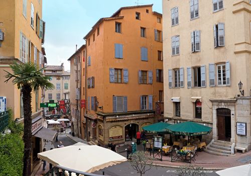 GRASSE, FRANCE - MAY 3: Architecture of Grasse Town in the southern France on May 3, 2013 in Grasse, France. Grasse is famous for its perfume industry. The city was founded in the XI century.

Grasse, France - May 3, 2013: Architecture of Grasse Town in the southern France. It is a city in the French department of Alpes-Maritimes. Grasse is famous for its perfume industry. The city was founded in the XI century. People stand on the street.