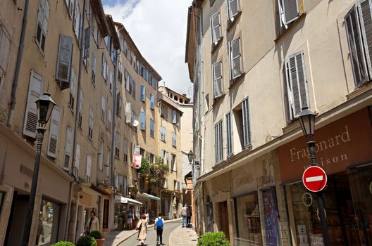GRASSE, FRANCE - MAY 3: Architecture of Grasse Town in the southern France on May 3, 2013 in Grasse, France. Grasse is famous for its perfume industry. The city was founded in the XI century.

Grasse, France - May 3, 2013: Architecture of Grasse Town in the southern France. It is a city in the French department of Alpes-Maritimes. Grasse is famous for its perfume industry. The city was founded in the XI century. People go along street.