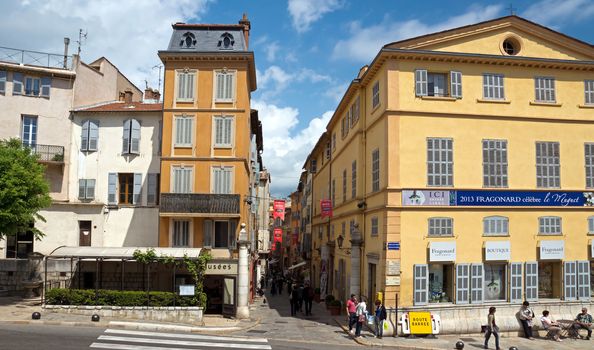 GRASSE, FRANCE - MAY 3: Architecture of Grasse Town in the southern France on May 3, 2013 in Grasse, France. Grasse is famous for its perfume industry. The city was founded in the XI century.

Grasse, France - May 3, 2013: Architecture of Grasse Town in the southern France. It is a city in the French department of Alpes-Maritimes. Grasse is famous for its perfume industry. The city was founded in the XI century. People go along street.