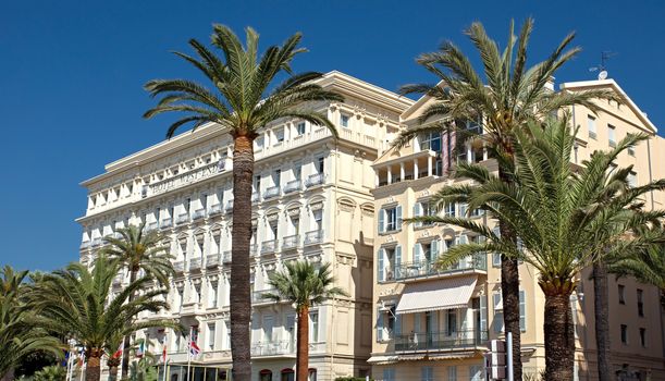 NICE, FRANCE - MAY 4: Architecture along Promenade des Anglais on May, 4, 2013 in Nice, France. It is a symbol of the Cote d'Azur and was built in 1830 at the expense of the British colony.

Nice, France - May 4, 2013: Architecture along Promenade des Anglais. People are walking. Promenade des Anglais is a symbol of the Cote d'Azur and was built in 1830 at the expense of the British colony.
