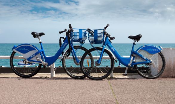 NICE, FRANCE - MAY 2: Two bicycle parked in front of the coast of the Mediterranean Sea on the Promenade des Anglais on May 2, 2013 in Nice, France. 

Nice, France - May 2, 2013: Two bicycle parked in front of the coast of the Mediterranean Sea on the Promenade des Anglais.