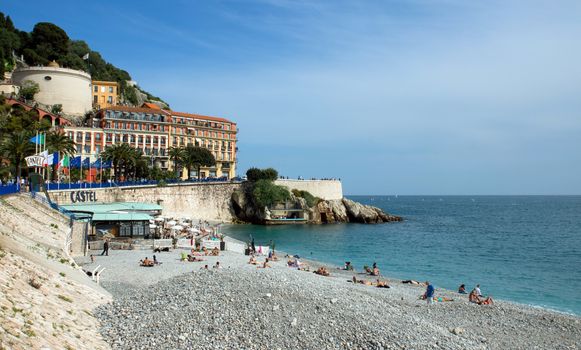 NICE, FRANCE - MAY 4: Beach Angel bay on May 4, 2013 in Nice, France. Citizens and tourists sunbathing enjoying a sunny day on the beach.

Nice, France - May 4, 2013: Citizens and tourists sunbathing enjoying a sunny day on the beach in Angel bay.