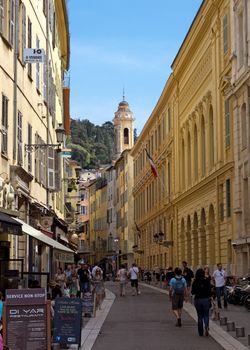 NICE, FRANCE - MAY 4: Architecture of old town on May 4, 2013 in Nice, France. 

Nice, France - May 4, 2013: Architecture of old town. There are many boutiques, cafes and restaurants. People are walking.