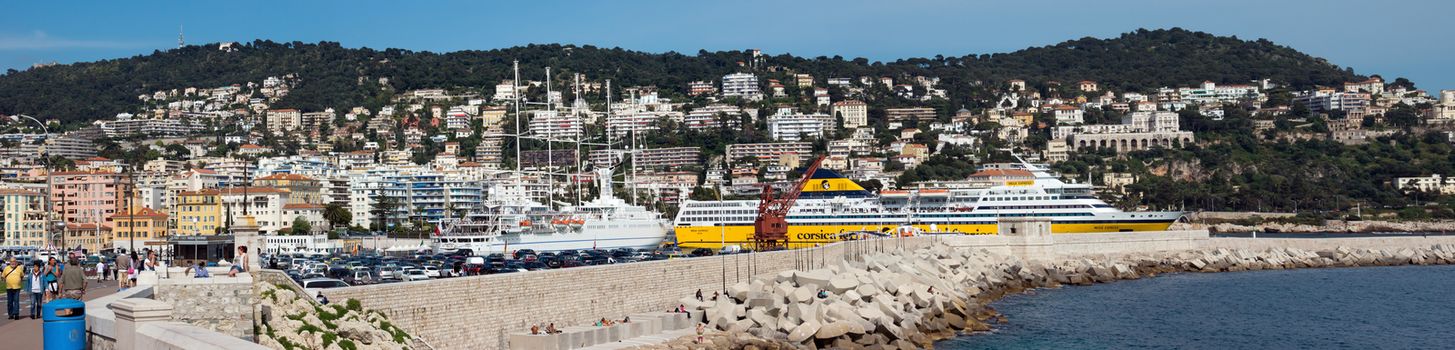 NICE, FRANCE - MAY 4: Panoramic view of Port de Nice on May 4, 2013 in Nice, France. Port de Nice was started in 1745.

Nice, France - May 4, 2013: Panoramic view of Port de Nice in French Riviera. Port de Nice was started in 1745. People are walking along Promenade.
