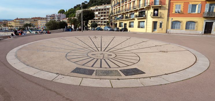 NICE, FRANCE - MAY 4: Sundial on Promenade des Anglais on May 4, 2013 in Nice, France. It is a symbol of the Cote d'Azur and was built in 1830 at the expense of the British colony.

Nice, France - May 4, 2013: Sundial on Promenade des Anglais. Promenade des Anglais is a symbol of the Cote d'Azur and was built in 1830 at the expense of the British colony. People are resting.