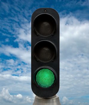 Green traffic lights against blue sky backgrounds. Clipping Path included.