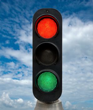 Red and Green traffic lights against blue sky backgrounds. Clipping Path included.