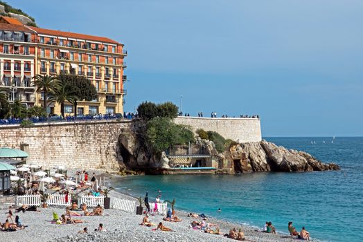 NICE, FRANCE - MAY 4: Beach Angel bay on May 4, 2013 in Nice, France. Citizens and tourists sunbathing enjoying a sunny day on the beach.

Nice, France - May 4, 2013: View on the Angel bay. Citizens and tourists sunbathing enjoying a sunny day on the beach in Angel bay.