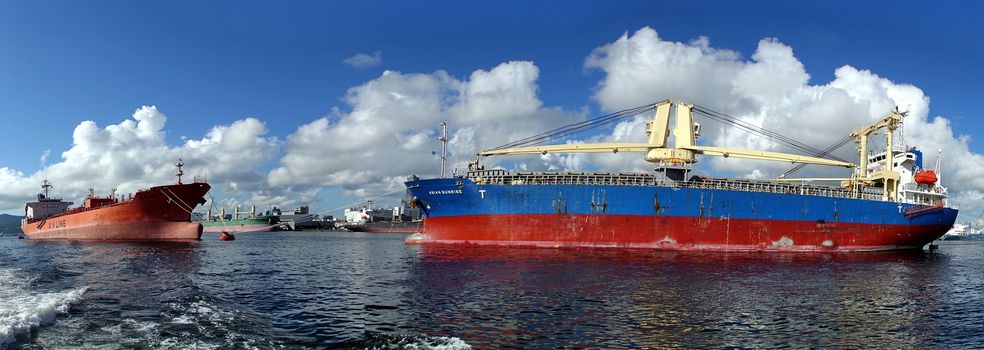 KAOHSIUNG, TAIWAN -- JUNE 2, 2019: Two large cargo ships are docked in Kaohsiung Port