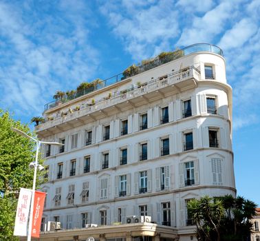 CANNES, FRANCE - MAY 6: Architecture of Cannes along the Croisette on May 6, 2013 in Cannes, France. City founded by the Romans in 42 BC.

Cannes, France - May 6, 2013: Architecture of Cannes along the Croisette. Cannes is a city located in the French Riviera. The city is also famous for its luxury shops, restaurants, and hotels. City founded by the Romans in 42 BC.