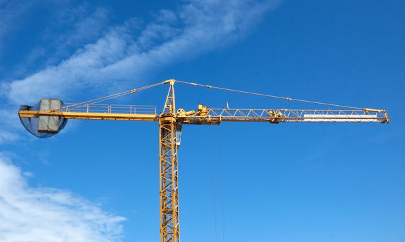 Construction site with crane over blue sky