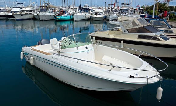 ANTIBES, FRANCE - MAY 6: Anchored boat in Port Grimaldi on May 6, 2013 in Antibes, France.

Antibes, France - May 6, 2013: Anchored boat in Port Grimaldi on the French Riviera.