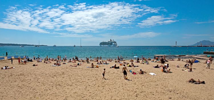 CANNES, FRANCE - MAY 6: People on the most popular beach - Plage de la Croisette on May 6, 2013 in Cannes, France. The famous beach on the Croisette, known for its filmfestival in may.

Cannes, France - May 6, 2013: People on the most popular beach in Cannes - Plage de la Croisette. The famous beach on the Croisette, known for its filmfestival in may. People are sun bathing, swiming and resting.