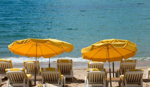Lounge chairs and parasol on the beach, southern France