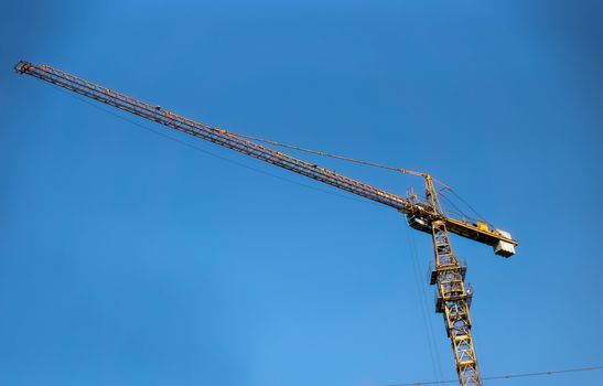 Construction site with crane over blue sky 