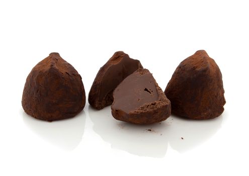 Chocolate truffles on white background.
