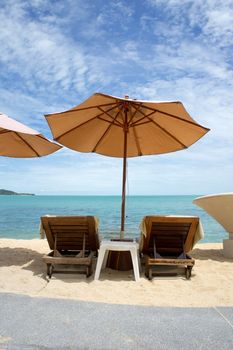 Beach umbrella and longues on the tropical sea