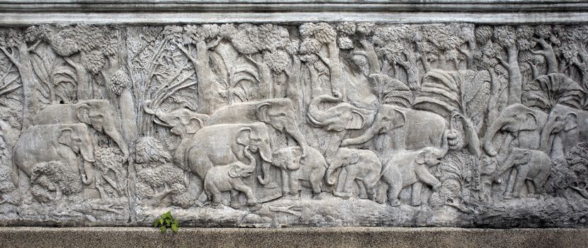Bas-relief composition of stone elephants in Thailand