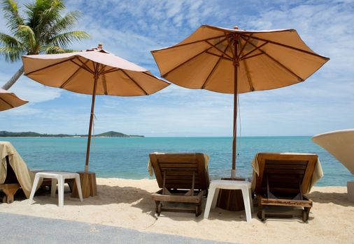 Chairs and umbrella on tropical beach