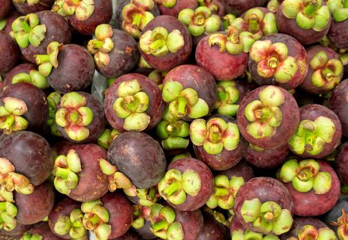 A lot of mangosteens in the market of Thailand 
