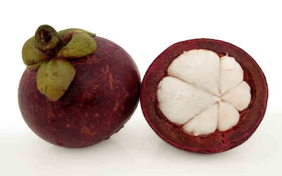 Mangosteen and cross section isolated on white. Clipping path included.