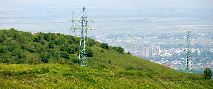 Power line in mountains overlooking the city
