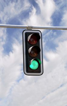 Green traffic lights against blue sky backgrounds with clipping path