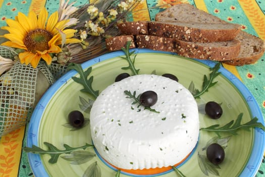 Fresh cheese with black olives