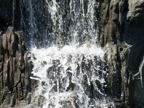 Forest waterfall in the Alps mountains in sunny day