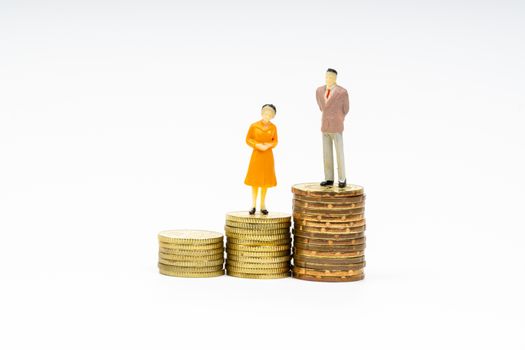 Miniature people standing on stacking coins with white background. Business and Lifestyle concepts.