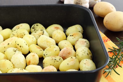 Roasted potatoes in black baking tin