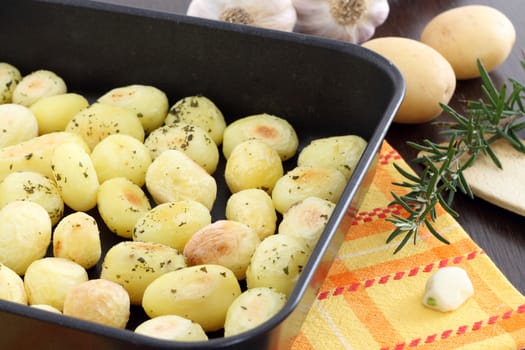 Roasted potatoes in black baking tin