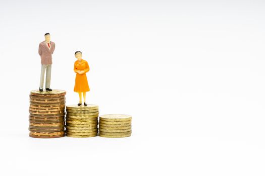 Miniature people standing on stacking coins with white background. Business and Lifestyle concepts.