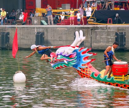 LINYUAN, TAIWAN -- MAY 21, 2017: An unidentified team that competes in the Dragon Boat Races at Zhongyun Fishing Port in Taiwan, reaches the finishing line.

