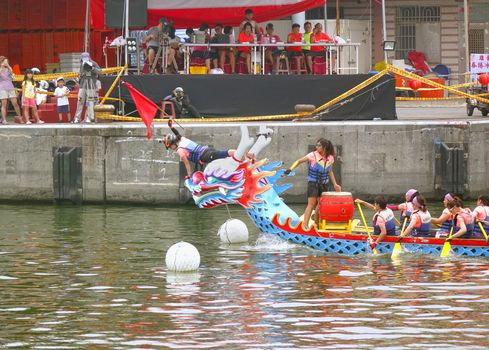 LINYUAN, TAIWAN -- MAY 28, 2017: An unidentified team that competes in the Dragon Boat Races at Zhongyun Fishing Port in Taiwan, reaches the finishing line.