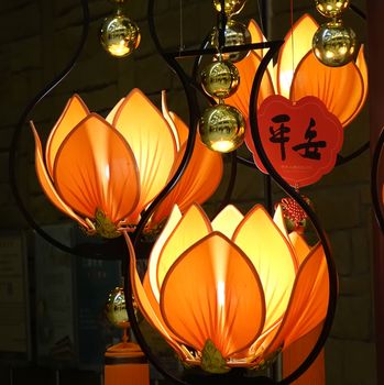 KAOHSIUNG, TAIWAN -- JANUARY 25, 2020: Lamps in the shape of the Buddhist symbol of lotus flowers. The Chinese word means "Peace".