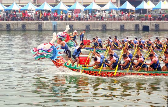 LINYUAN, TAIWAN -- MAY 28, 2017: Two unidentified teams compete in the Dragon Boat Races at Zhongyun Fishing Port in Taiwan.