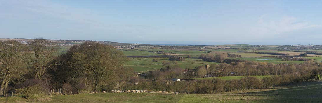 Panoramic view over rural countryside farming landscape with fields in a valley
