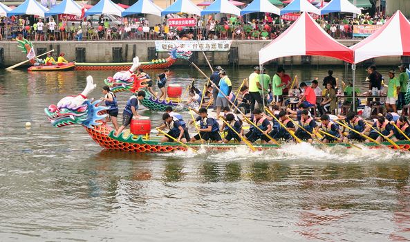 LINYUAN, TAIWAN -- MAY 28, 2017: Two unidentified teams compete in the Dragon Boat Races at Zhongyun Fishing Port in Taiwan.