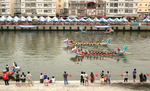 LINYUAN, TAIWAN -- MAY 28, 2017: Two unidentified teams compete in the Dragon Boat Races at Zhongyun Fishing Port in Taiwan.