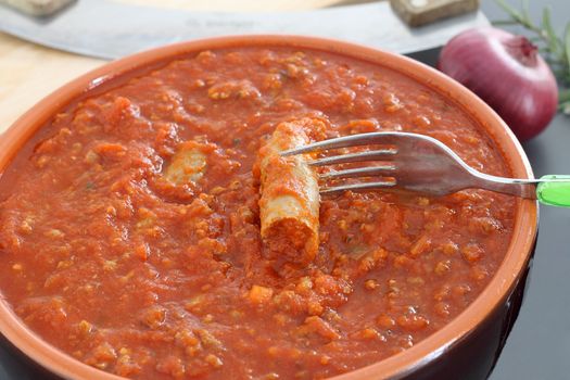 Bolognese sauce with sausage in terracotta pan