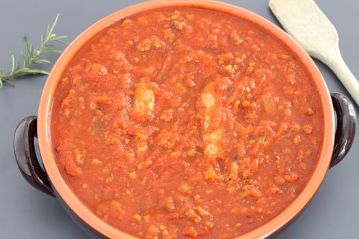 Bolognese sauce with sausage in terracotta pan