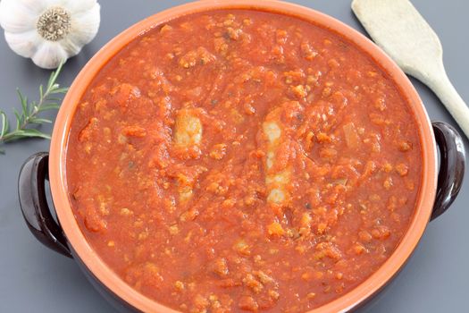 Bolognese sauce with sausage in terracotta pan