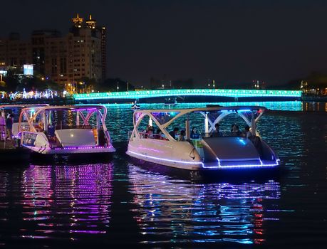 KAOHSIUNG, TAIWAN -- FEBRUARY 13, 2016: Tourists ride in pleasure boats on the Love River during the 2016 Lantern Festival.
