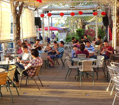 KAOHSIUNG, TAIWAN -- FEBRUARY 13, 2016: Tourists and visitors enjoy the riverside coffee shops along the Love River during the 2016 Lantern Festival.
